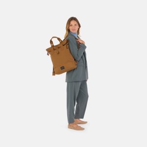 woman standing wearing city bikepack toffee as backpack on one shoulder