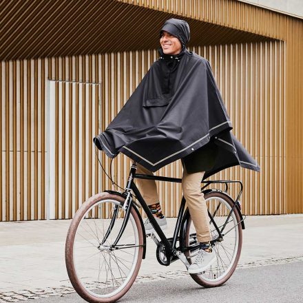 man cycling wearing imbris rain poncho black