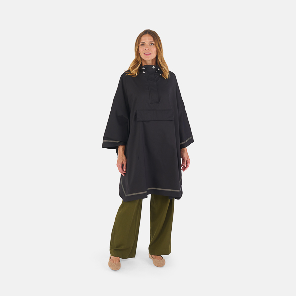 woman standing wearing imbris rain poncho black hood down