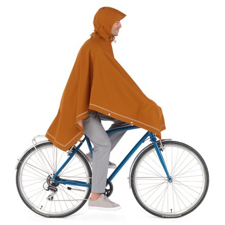 man cycling wearing weathergoods imbris rain poncho copper using handle bar tabs and adjustable hood
