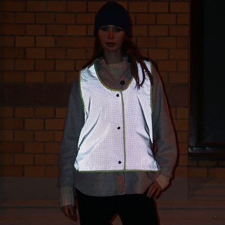woman wearing weathergoods refelctive vest luna dot at night